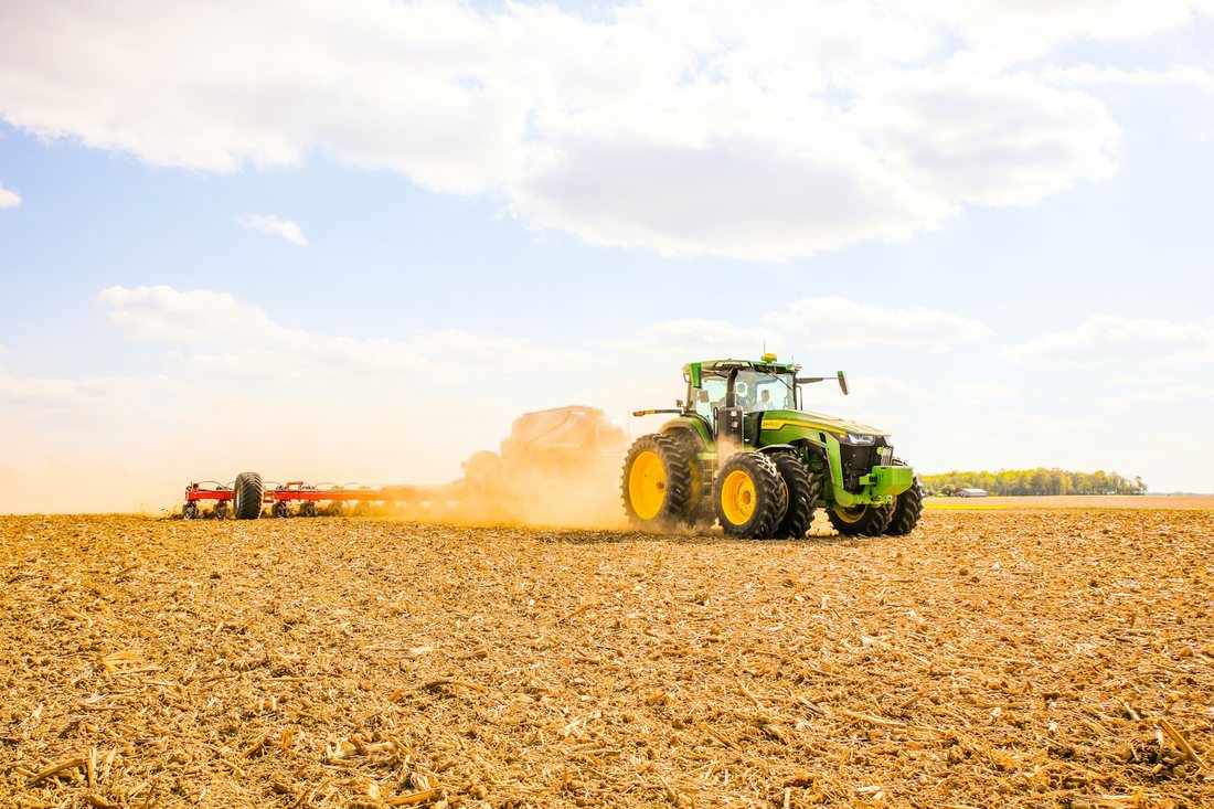 John Deere tractor working a field