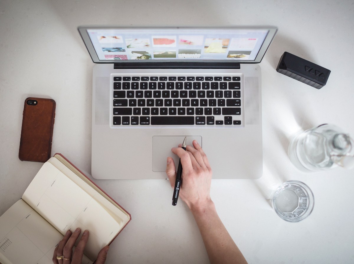 Laptops and mobile phones set out on a desk in an office